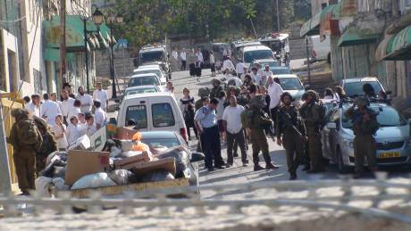 Click on image to see full-sized version Settlers and Israeli Occupation Forces behind the gate that protesters blocked in Hebron