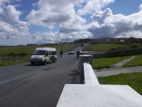 At Pullathomas graveyard, garda� escort Shell's traffic on foot