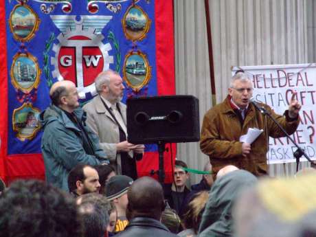 M�che�l � Seighin and Mick O'Reilly watch on while Joe Higgins gives it yards on the stump.