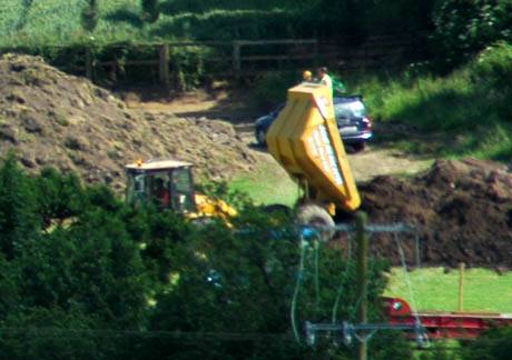The Tipper truck, the soil of Tara and 2 relaxed Archeologists enjoying the sun.. There is gold in that there hill (well euros anyway)..