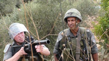 Click on image to see full-sized version IOF soldier about to fire at Nabi Saleh protest