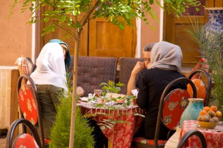 Click on image to see full-sized version Man and two women in the traditional restaurant in the city of Yazd