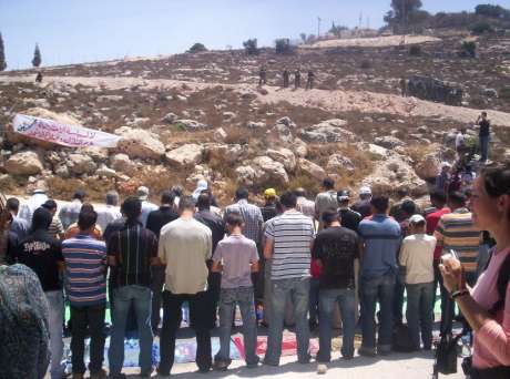 Click on image to see full-sized version Palestininians pray before demonstration against the Annexation Wall